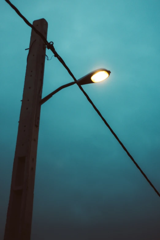 a street light on a power pole with a blue sky background