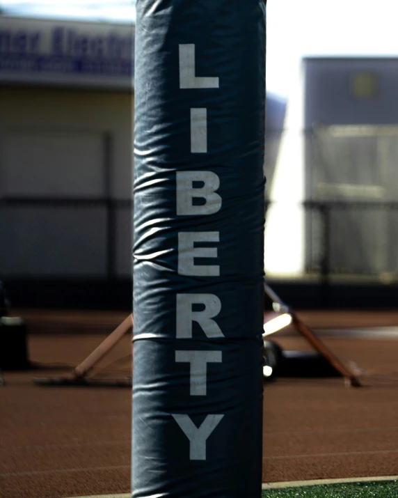 a black tube and ball sitting on a court