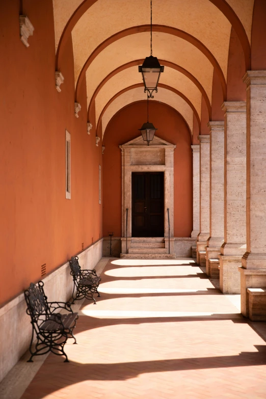 a hallway with two benches in front of it