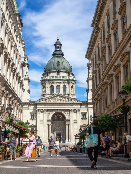 a church and an old building with many people walking in front