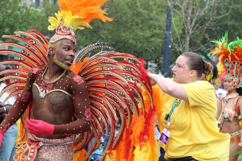 two women dance with different colorful costumes at the carnival