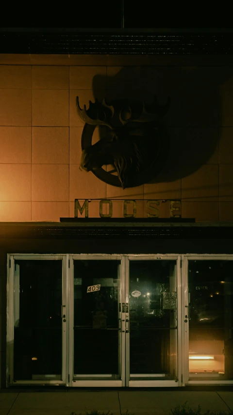 the entrance to a restaurant at night with lighted door