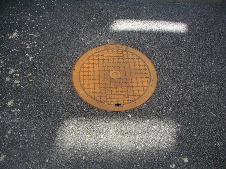 a manhole cover for drainage water on the sidewalk