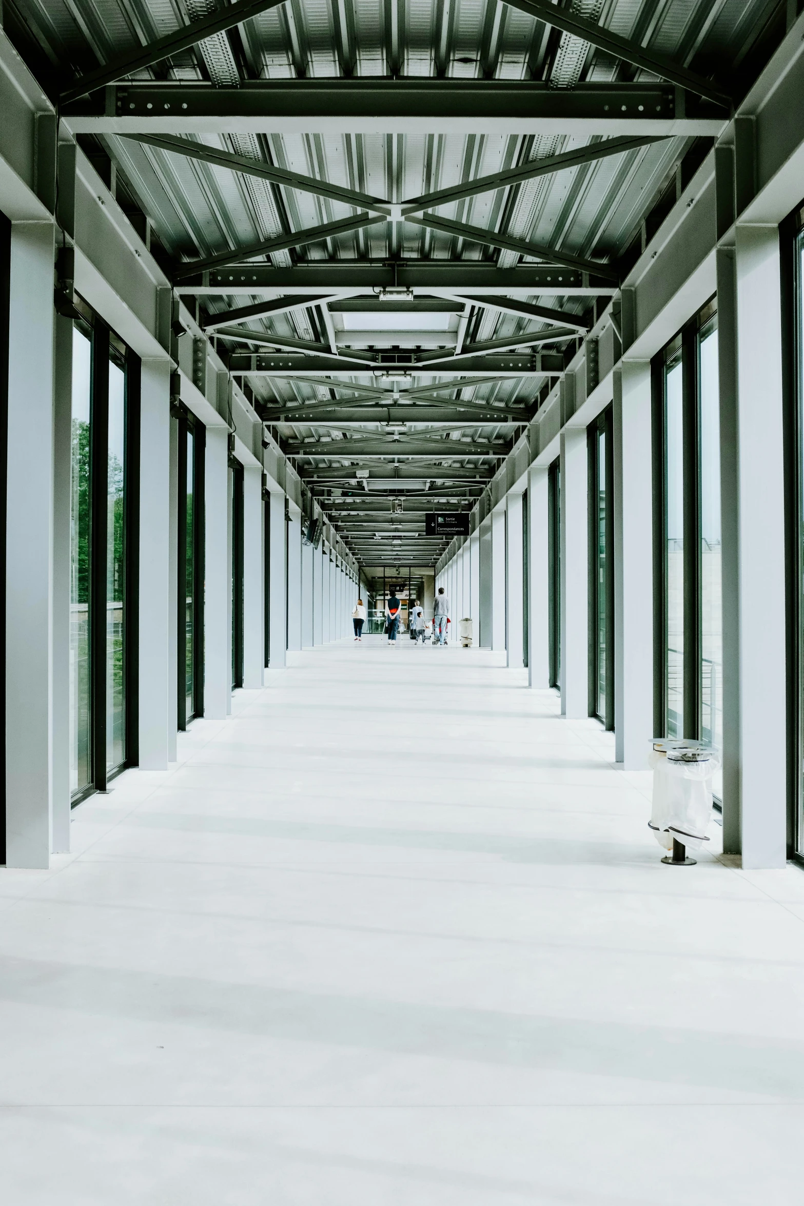 inside an airport walkway covered in glass with lots of windows