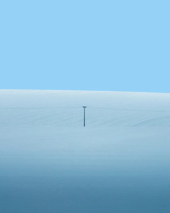 a tall pole sitting over a blue field