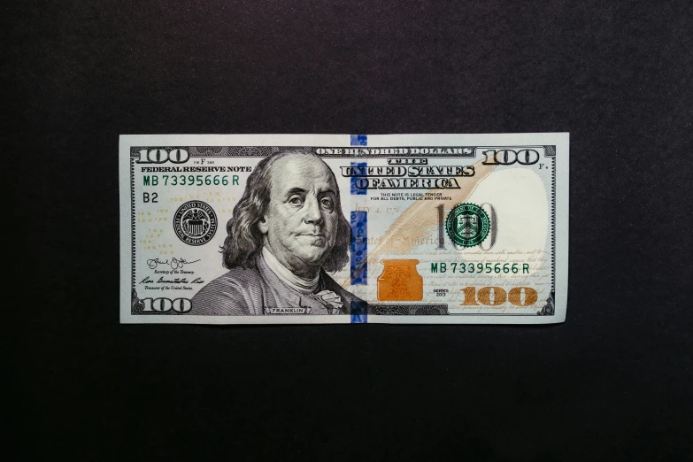 dollar bill with a hole in the center is on display