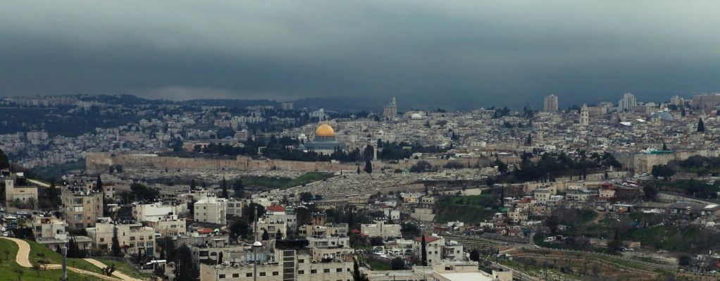 an aerial view of a city from a very high hill