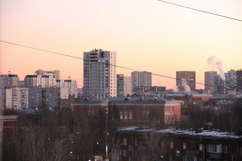 a group of buildings in the background of power lines