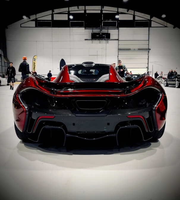 people look at a car on display at a vehicle show