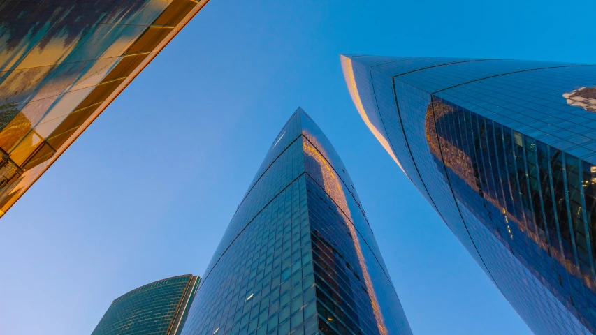 two tall buildings with an upward view in a city