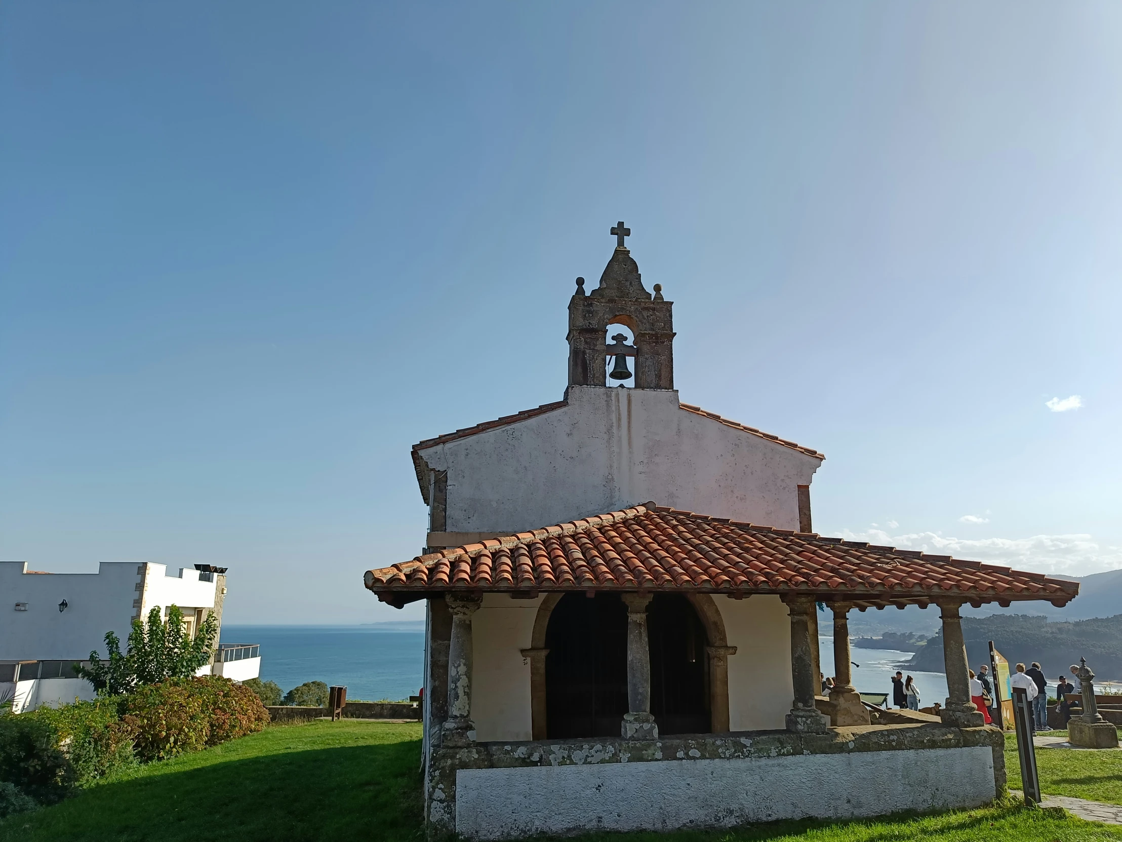 there is a small church near the ocean