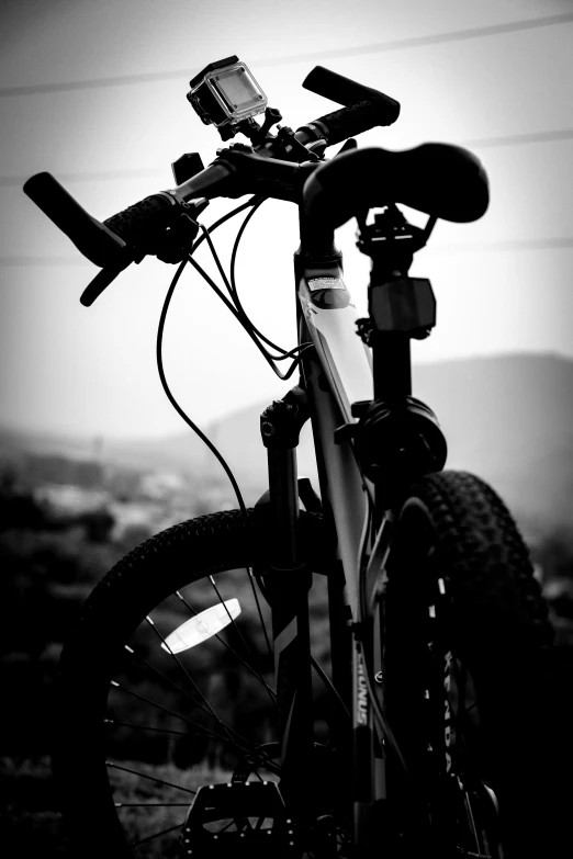 a bicycle parked next to a tall hillside