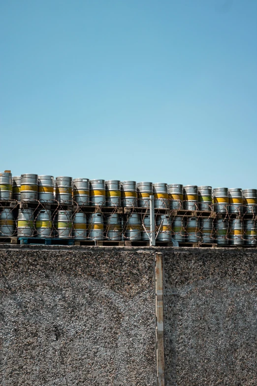 cans sitting on top of a large wall