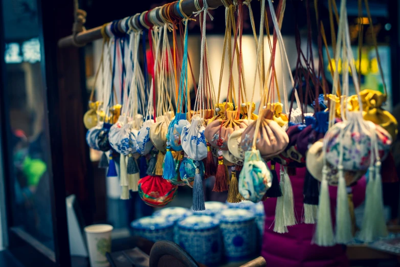 many purses and purses hanging from rope to store