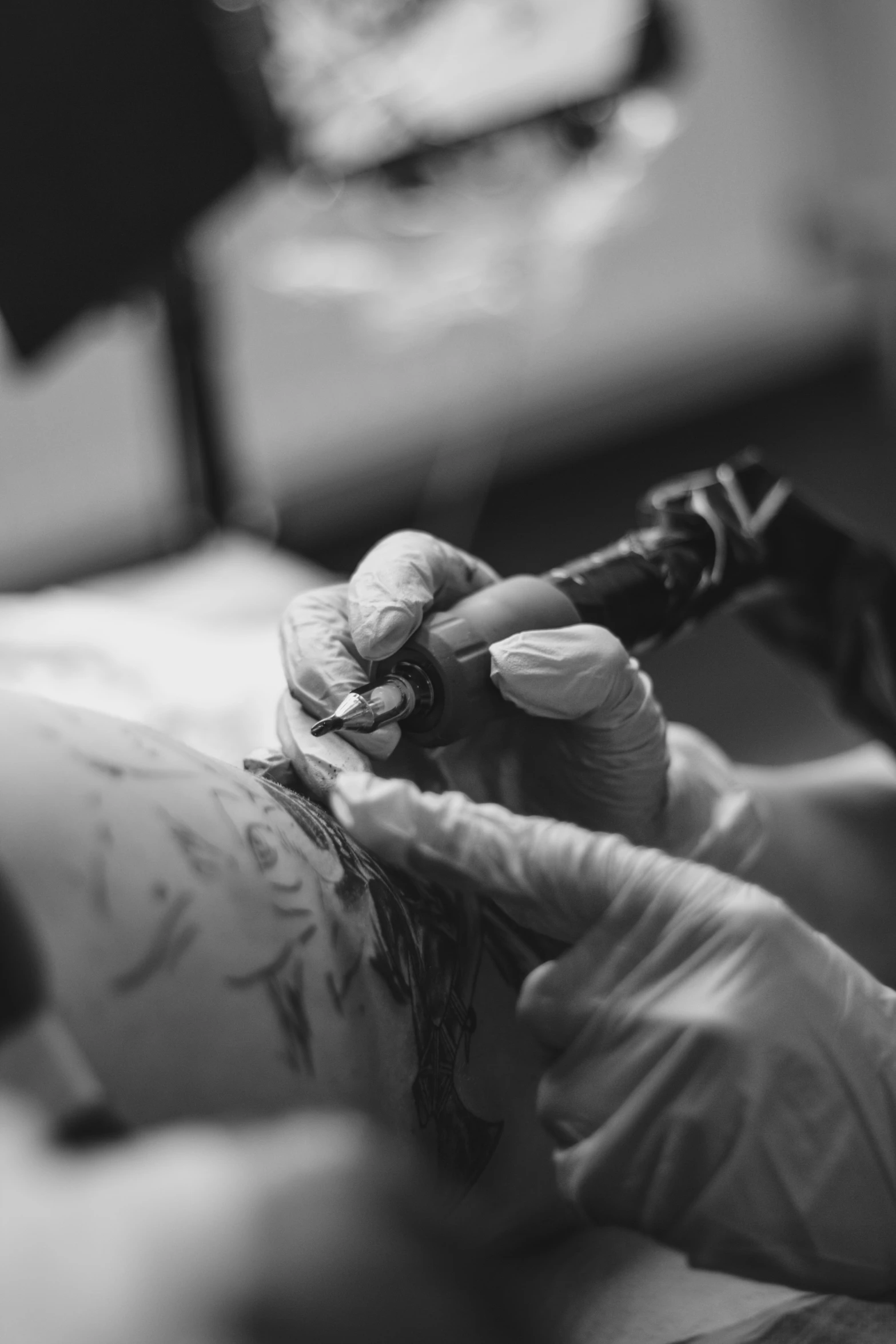 a woman getting her tattoo done using a small pair of scissors