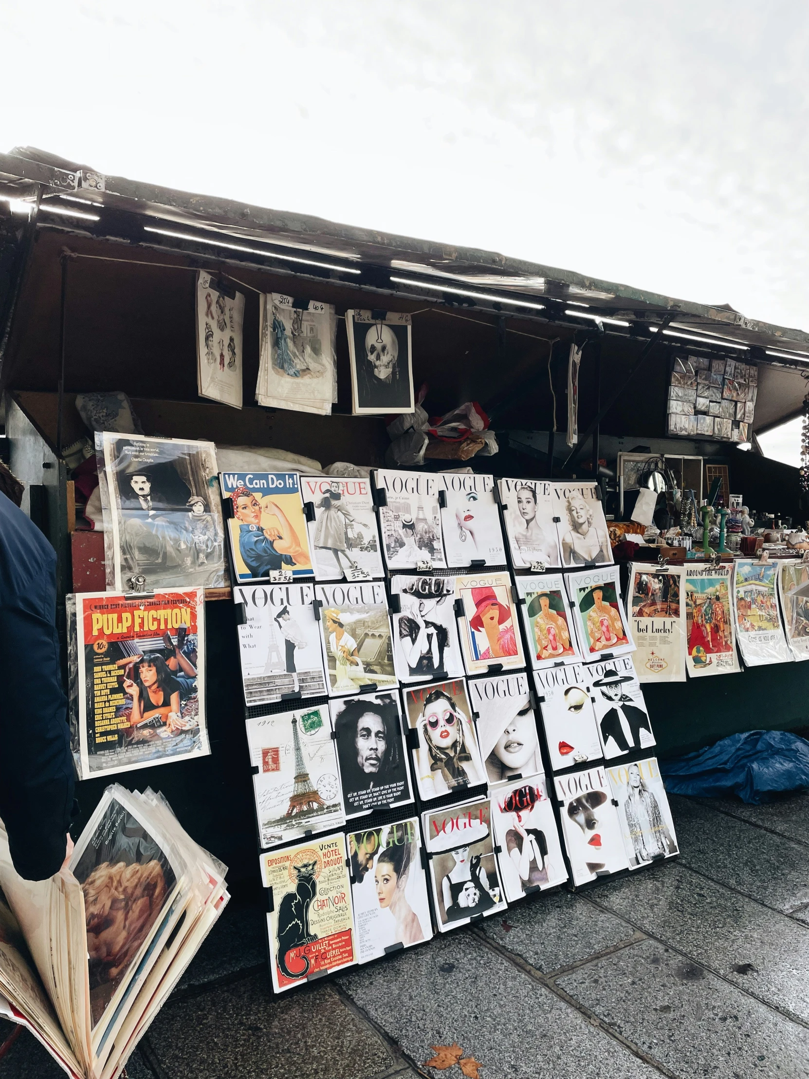 a man is browsing through the marketplace with many magazines