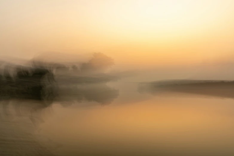 an artistic po of fog at sunset and water