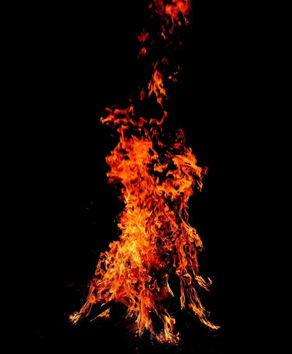 a large bonfire on a black background burning