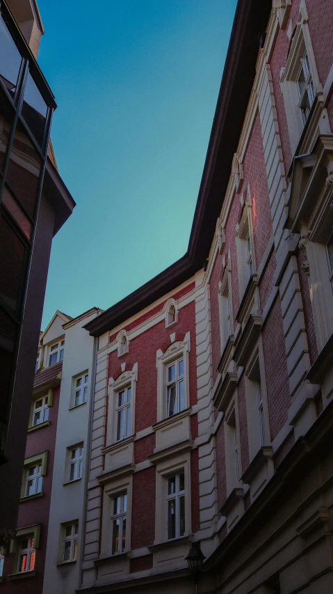 an old building with three stories stands among others