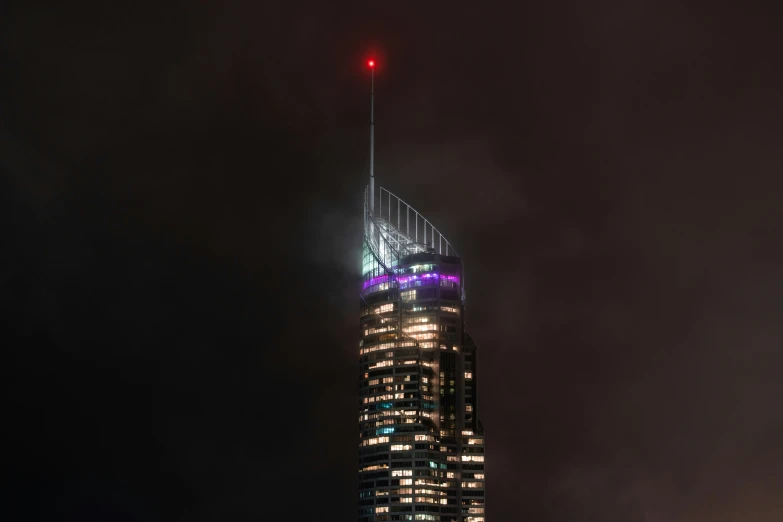 there is a tall building that is lit up at night