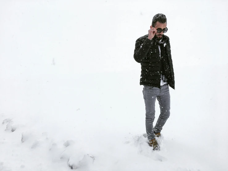 a man standing in a deep snow covered field