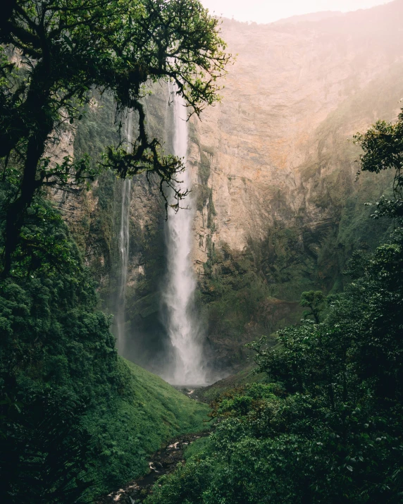 an incredible view of a large waterfall on a sunny day