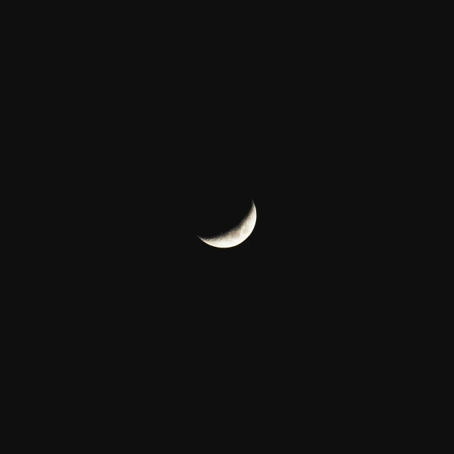 the moon and two smaller white phases in a black sky