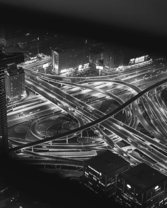 black and white view of freeway intersection in city at night