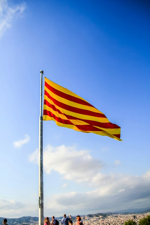 a large flag is in the air in front of a crowd