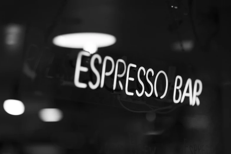 a black and white po of the sign for espresso bar