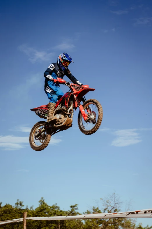 a man flying through the air while riding on top of a dirt bike