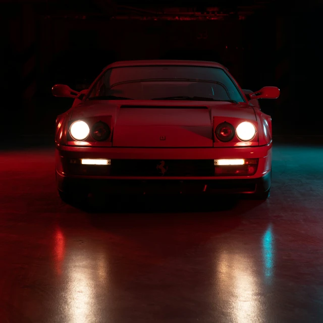 a car with its headlights on and a red background