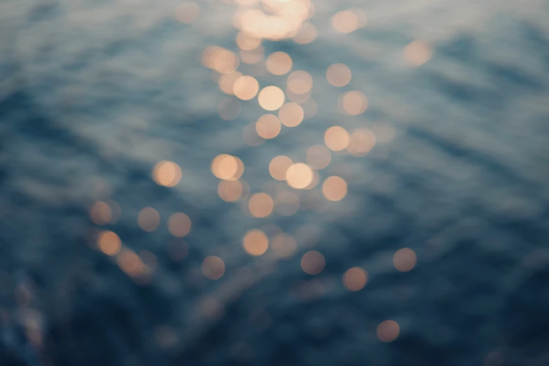 a blurry view of the sea as it reflects in the water