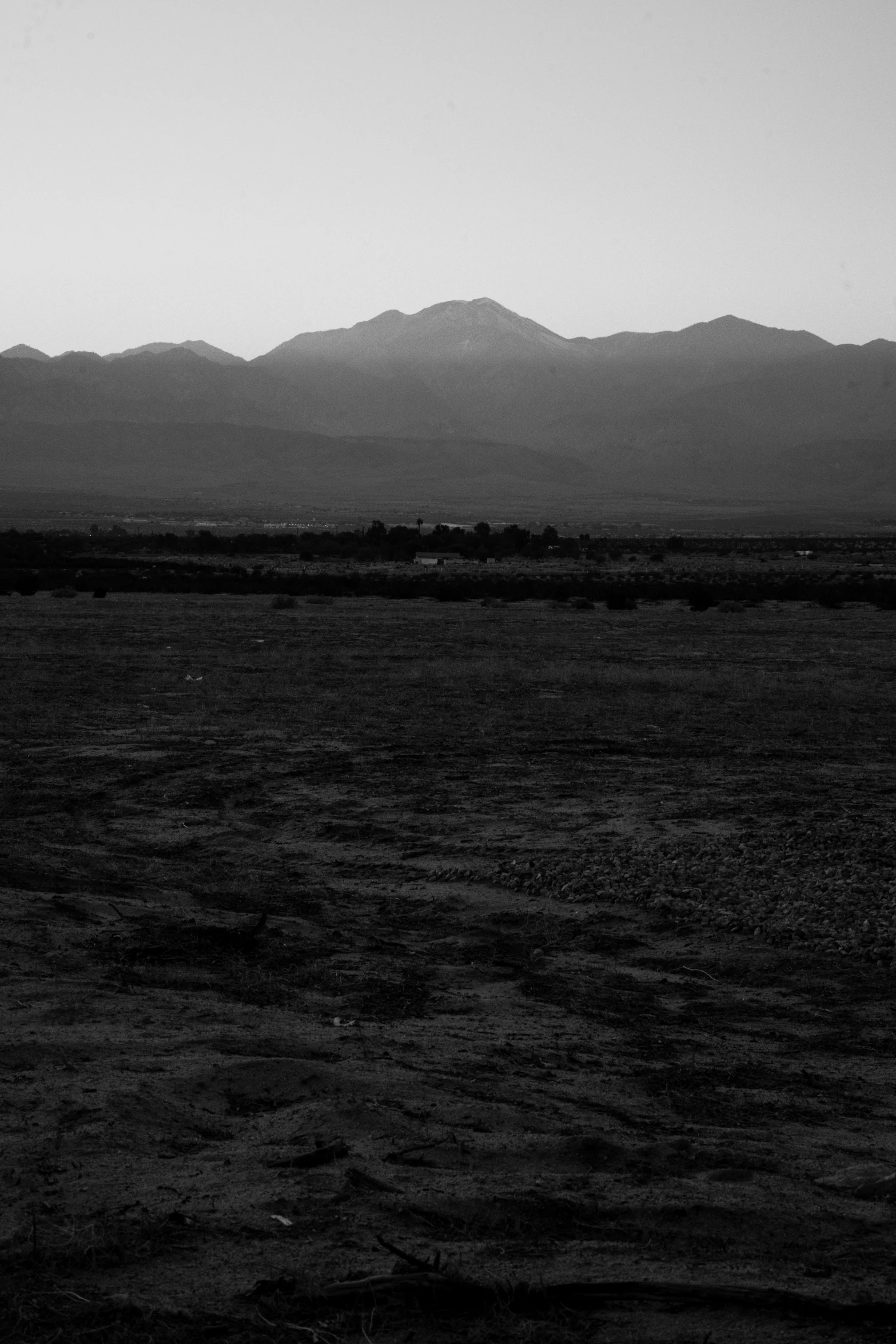 a black and white po of a lake with mountains in the background