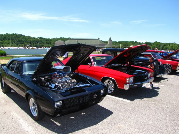 a row of old muscle cars parked next to each other