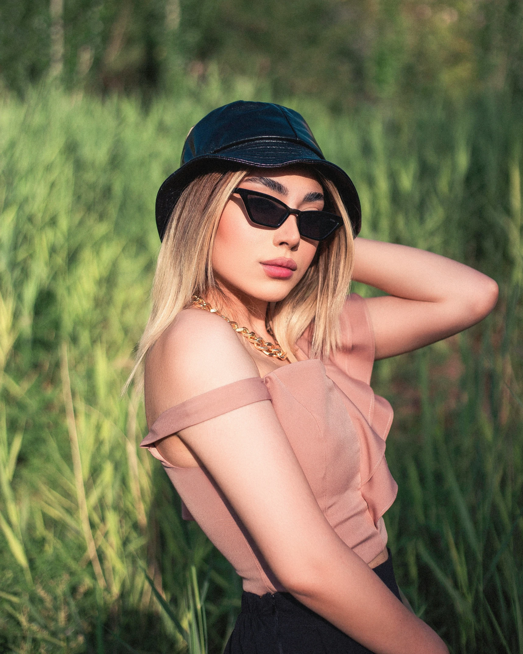 a beautiful young blond wearing sunglasses and a hat