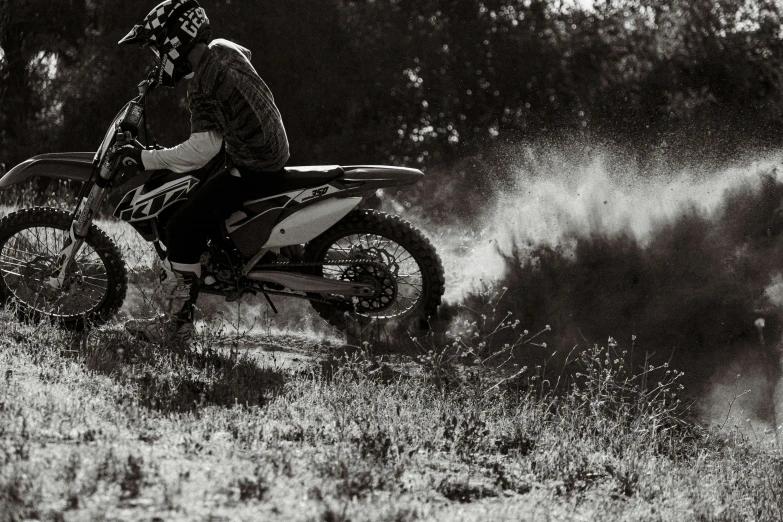 a dirt bike rider is riding on the ground