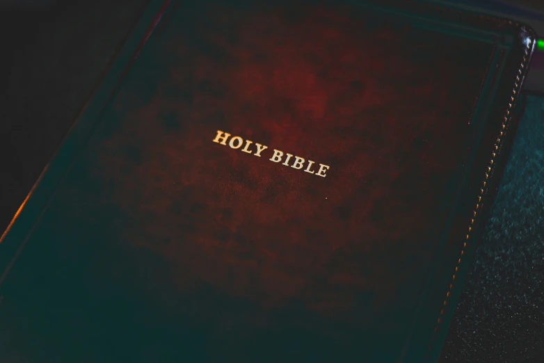 the holy bible is opened on the table
