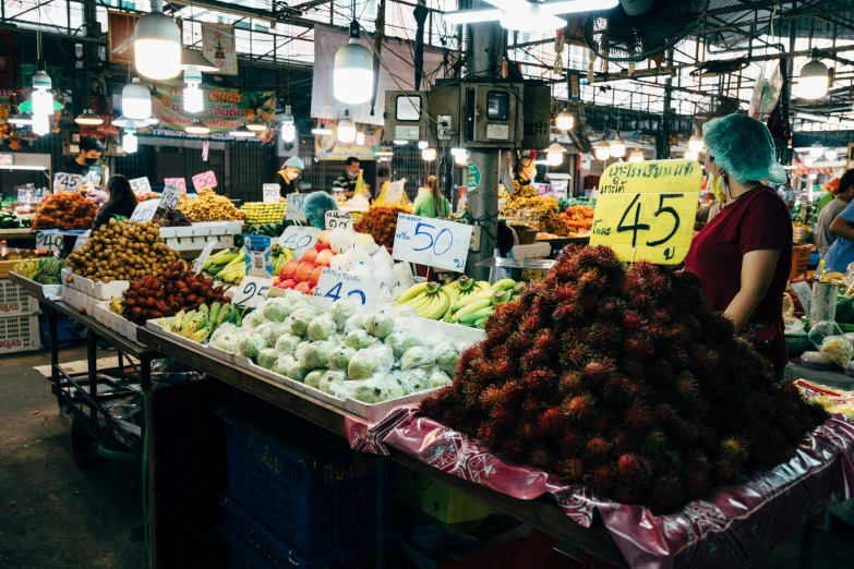 a large amount of fruit and produce are arranged for sale