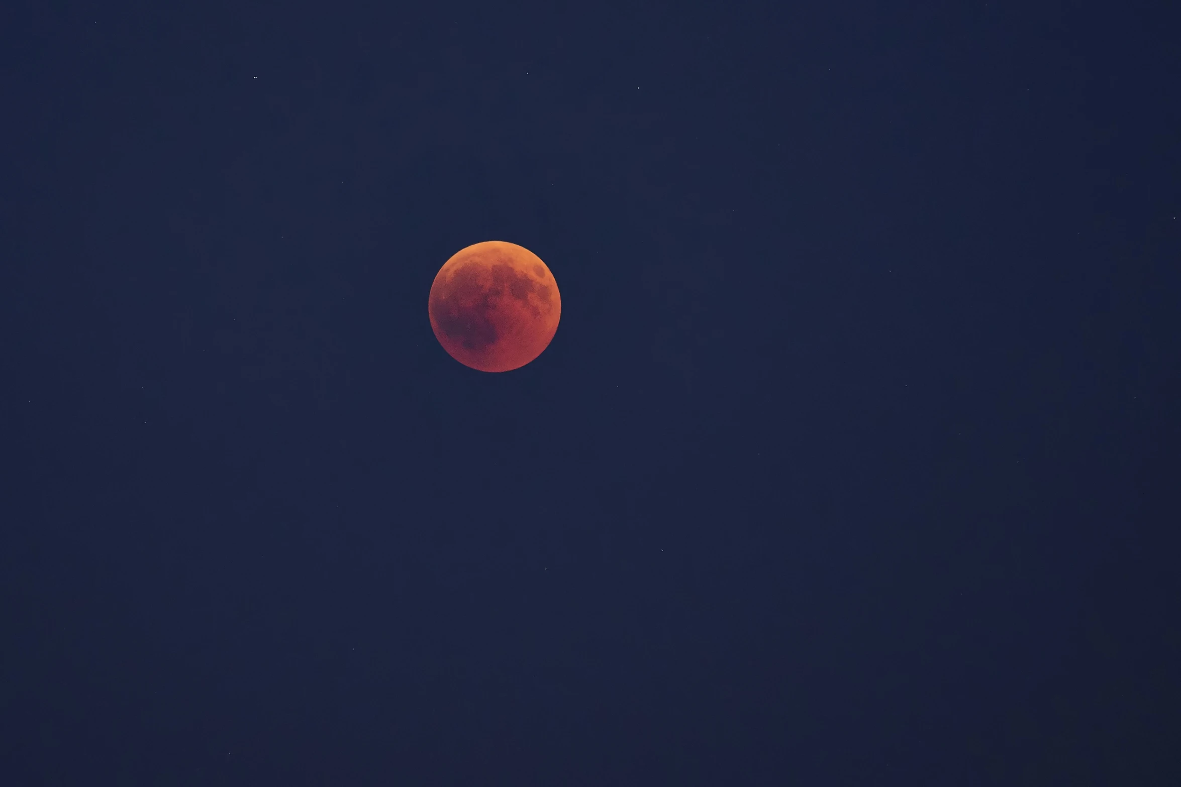 the red moon rising in the dark night sky
