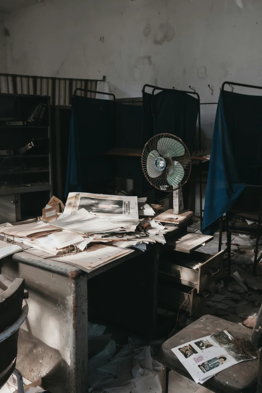 a messy room with a table and many chairs