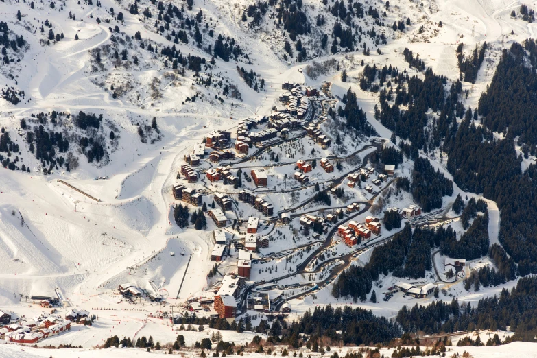 a small town nestled among a mountain covered in snow