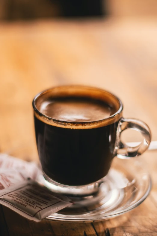 cup of coffee sitting on top of a table