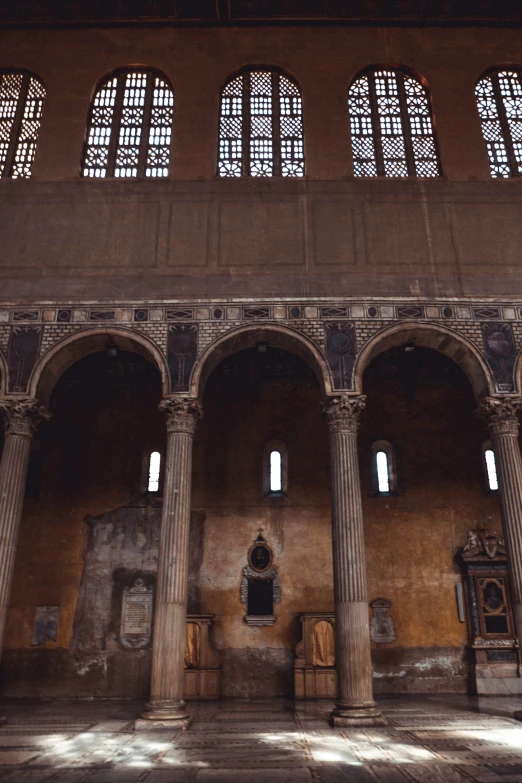 the inside of a castle with three archways and several columns