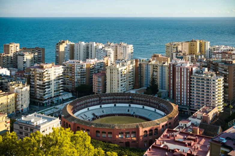 a city with buildings and an aerial view of the ocean