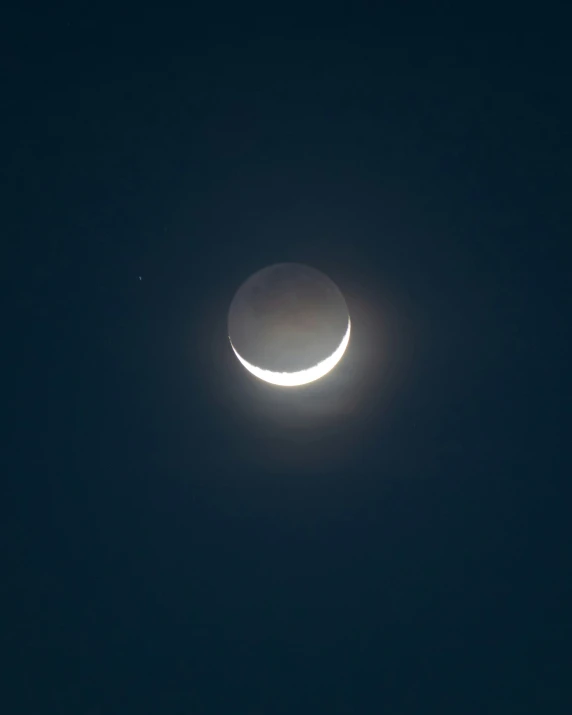 a crescent is lit up in the sky