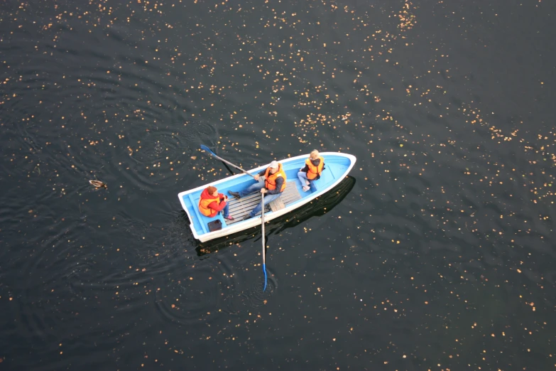 a group of people in a small boat in the water