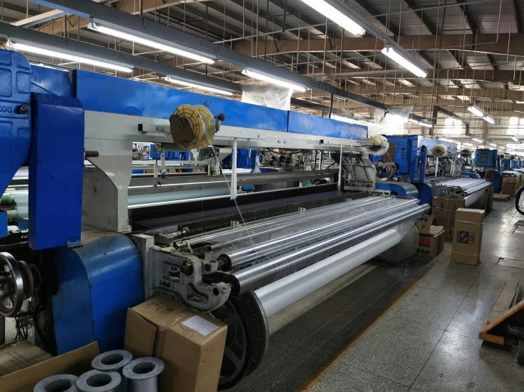 a large machine making rolls inside of a warehouse