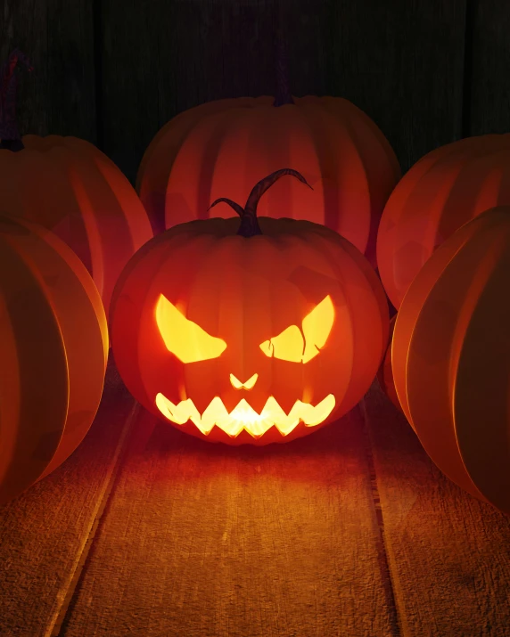 three pumpkins in their faces, lit by the light of a candle