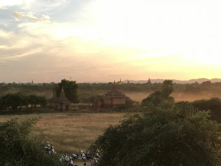 bikes in front of a large, ancient temple at dusk